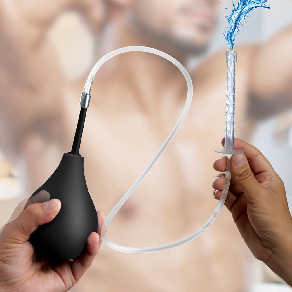 Silicone enema bulb kit with tubing and three tips, with water spraying from one tip.