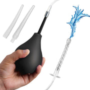 Silicone enema bulb kit with tubing and three interchangeable tips, with water splashing from one tip.