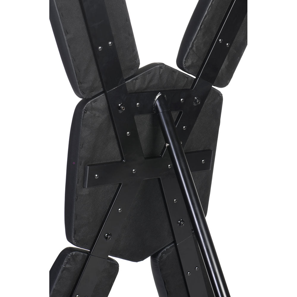 Close-up of the black metal frame and padded sections of a St. Andrew's Cross.