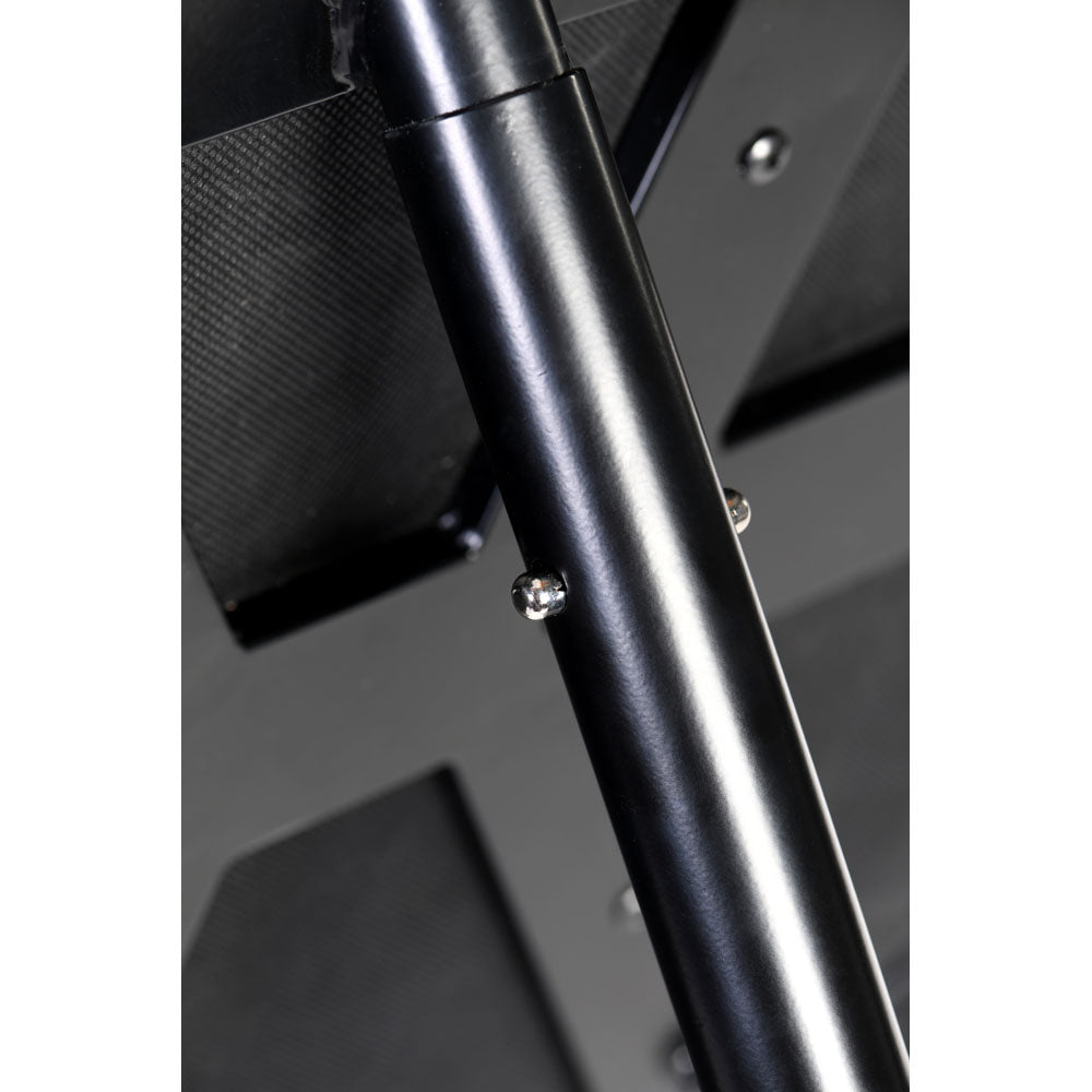 Close-up of a black metal pole with two silver screws on a St. Andrew's Cross.