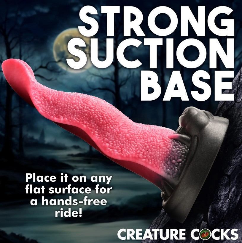 Pink textured tongue dildo emerging from a black wolf muzzle with a suction cup base.