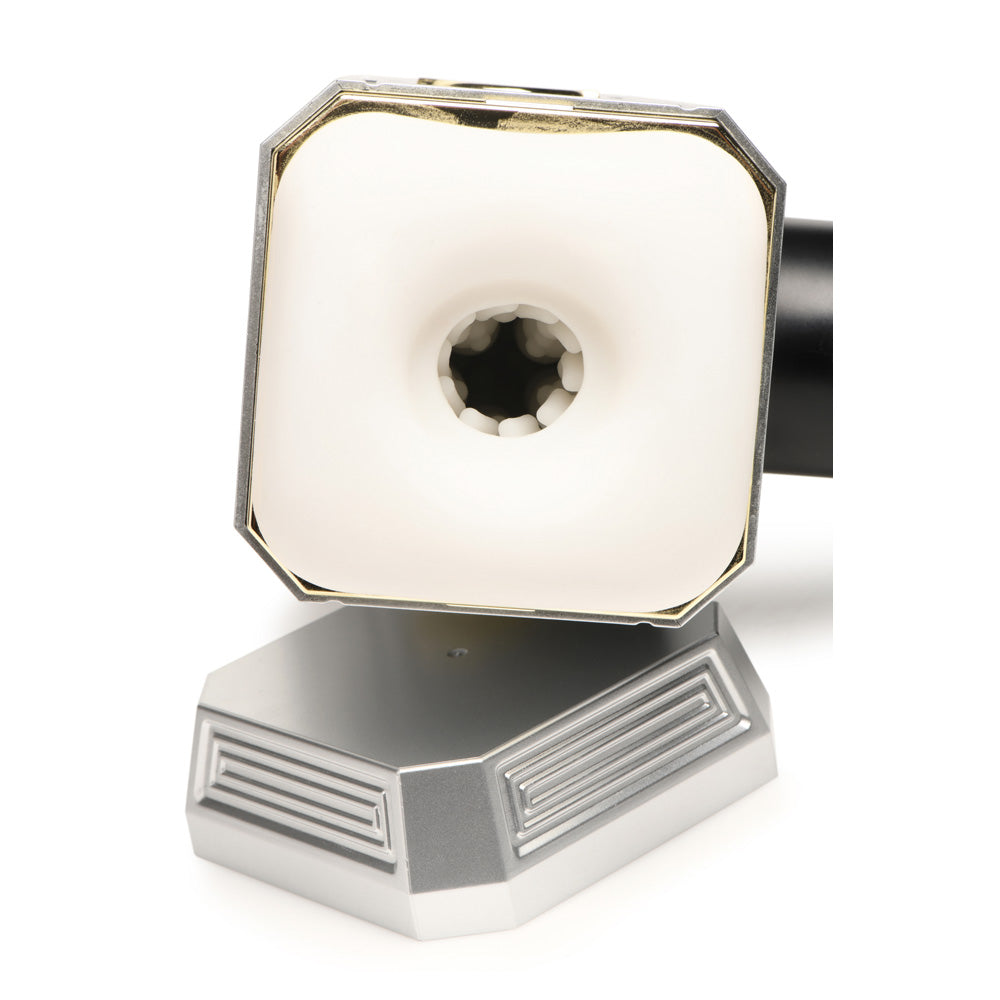A silver and white vibrating hammer toy with a textured opening.
