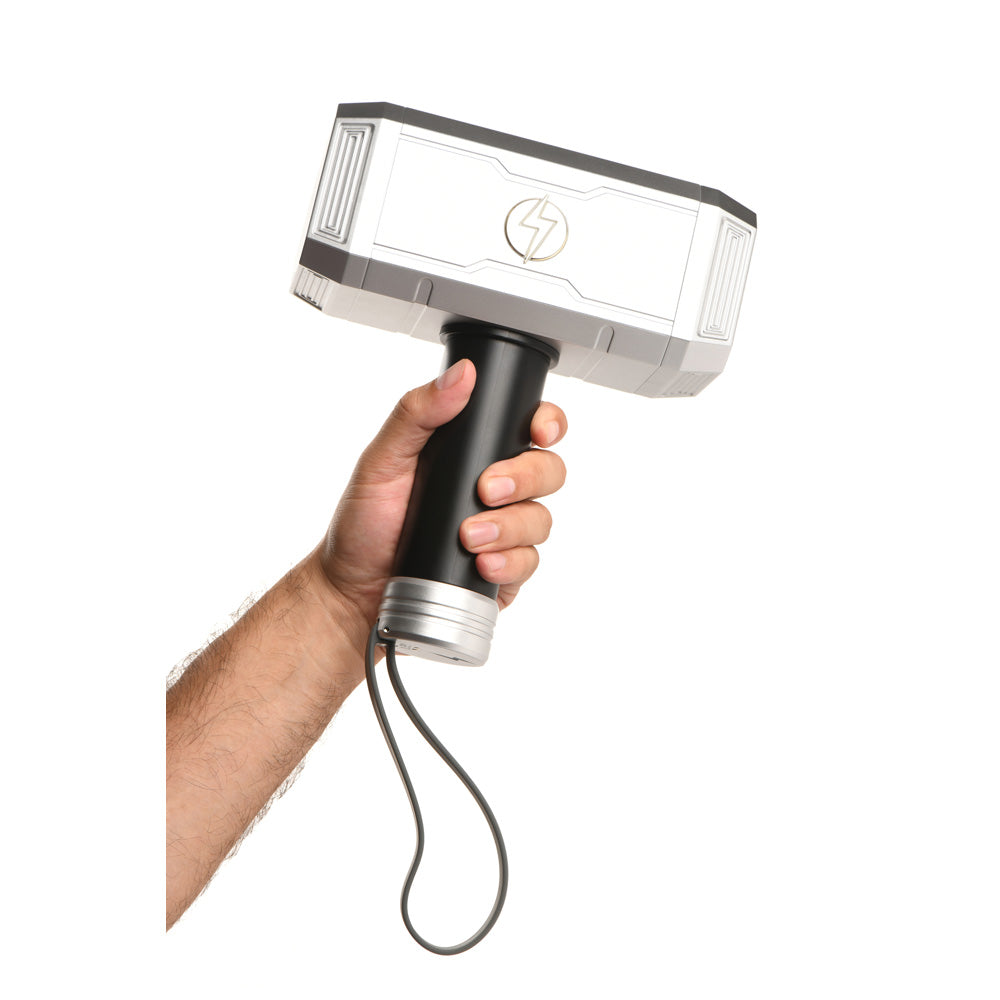 A hand holds a silver and black vibrating hammer with a lightning bolt symbol.