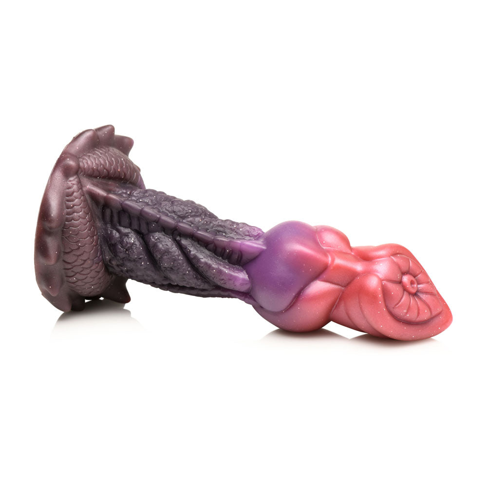 A purple and pink fantasy dildo with textured ridges and a suction cup base.