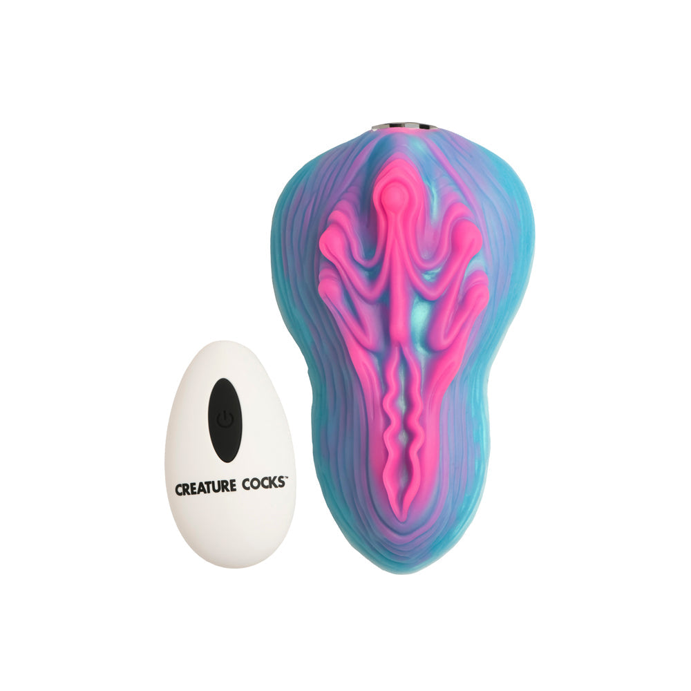 A blue and pink silicone vulva-shaped vibrator with a white remote.
