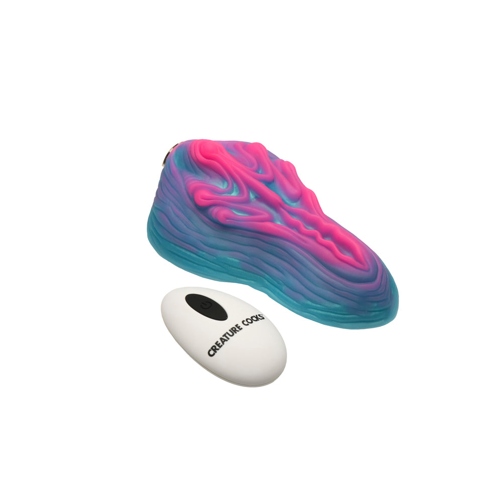 A pink and blue silicone grinder with a white remote.