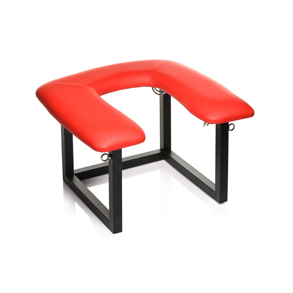 Red vegan leather queening chair with black metal frame and D-rings.