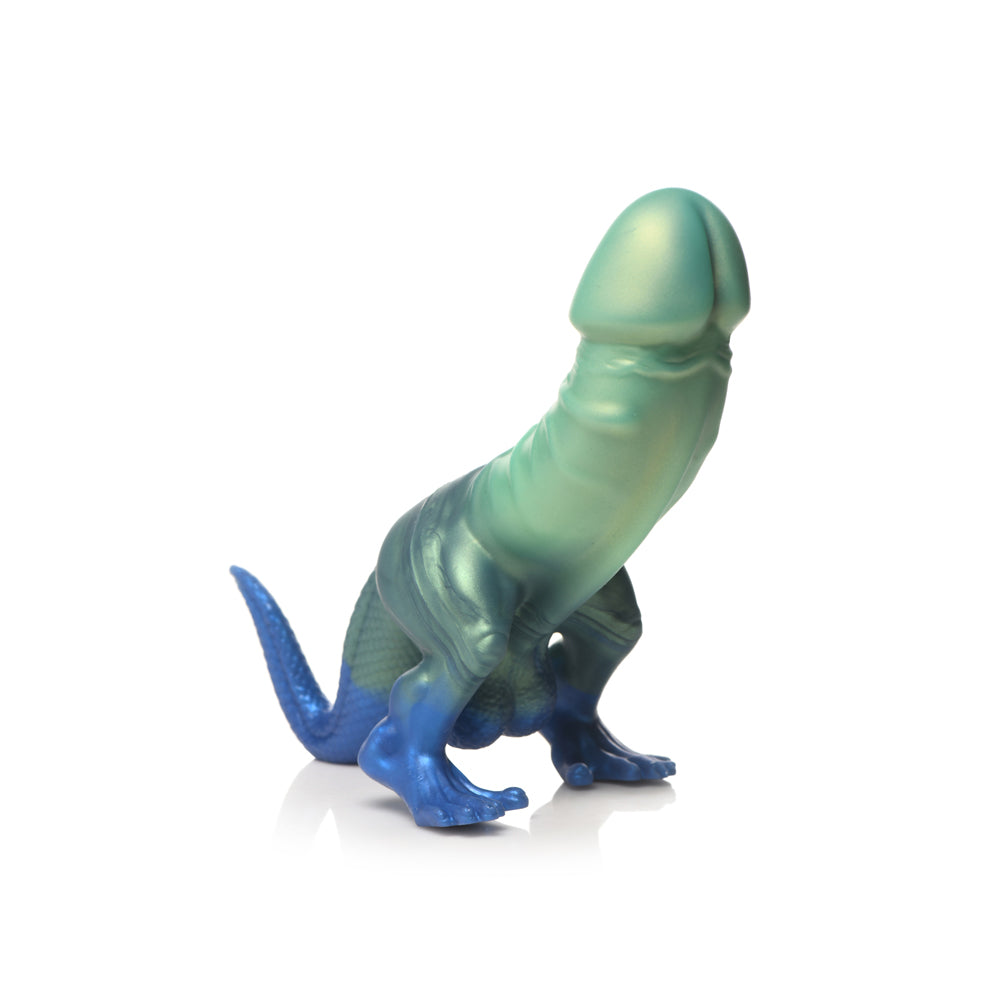 Glittery blue-green silicone dildo with dinosaur-like design and suction cup base.