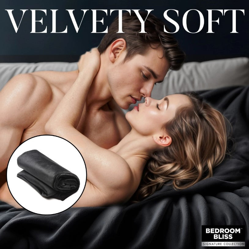 A black velvet throw blanket is shown with a couple embracing.