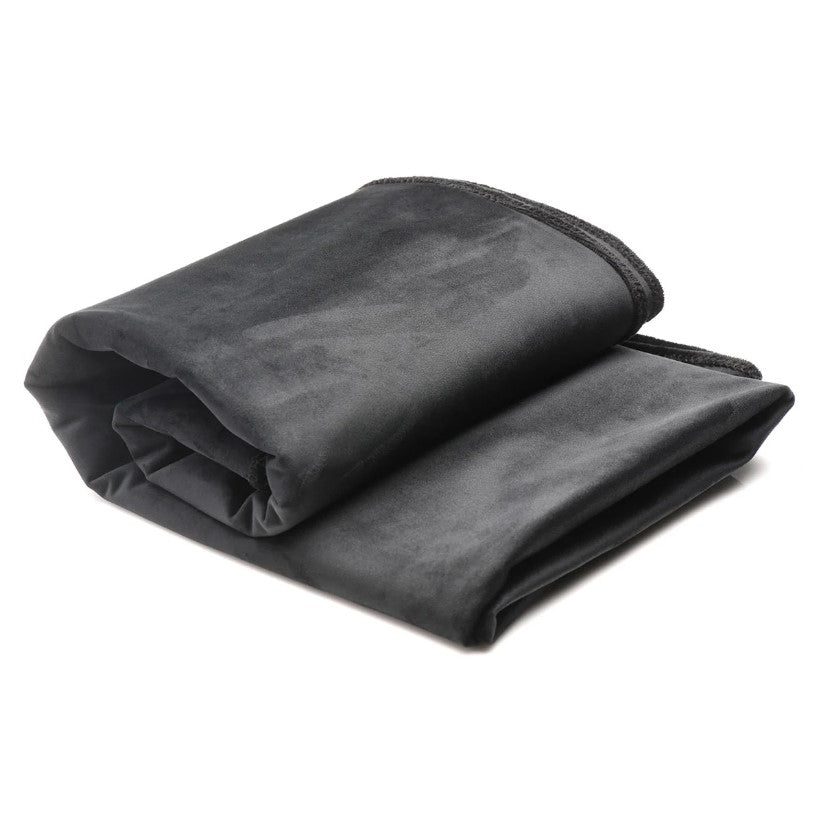 A folded dark gray velvet waterproof throw blanket.