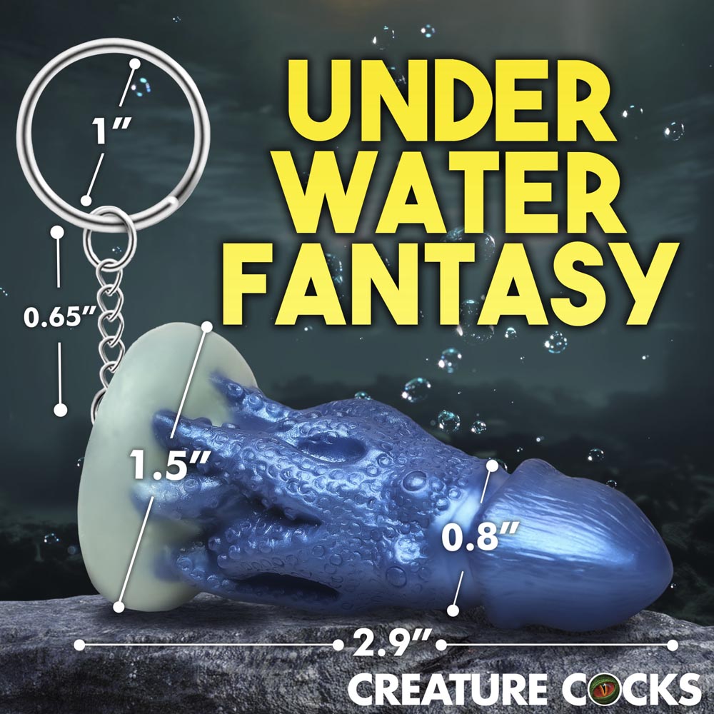 Blue silicone octopus creature keychain with measurements.