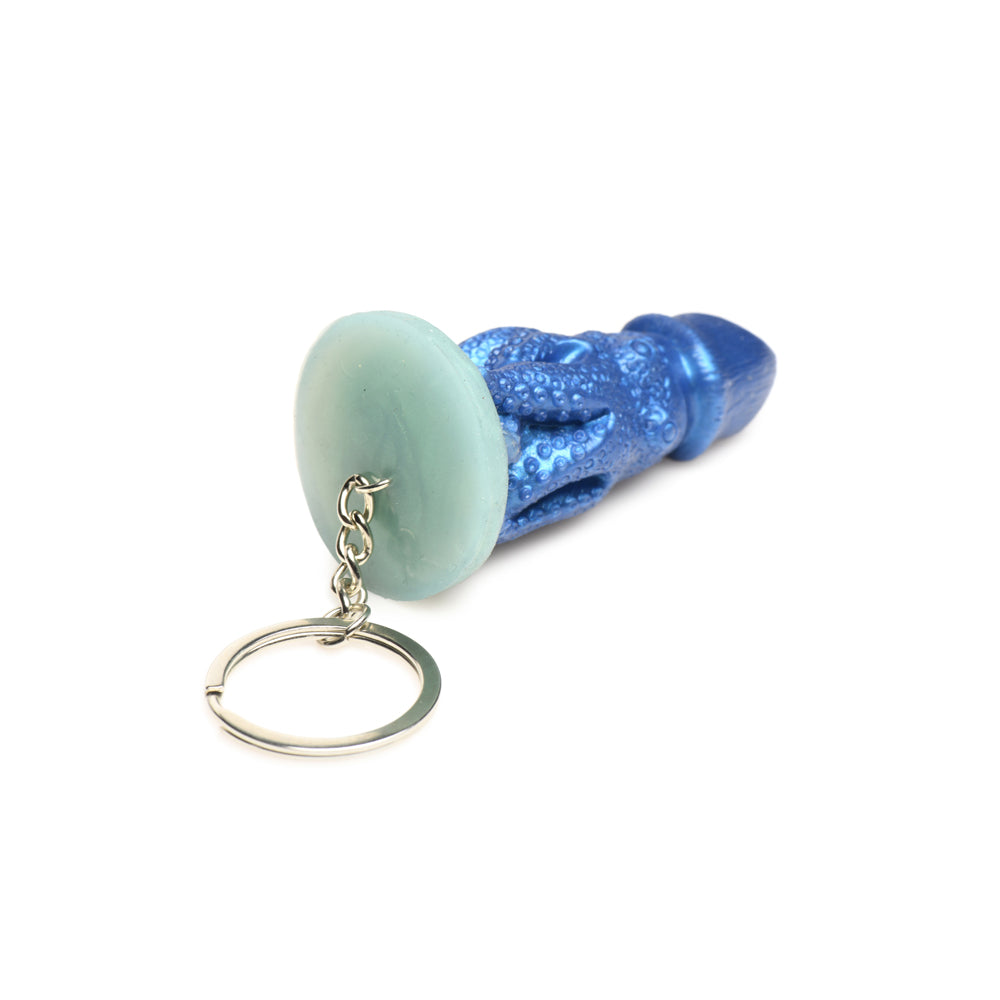 Blue silicone octopus creature keychain with a light green stone.