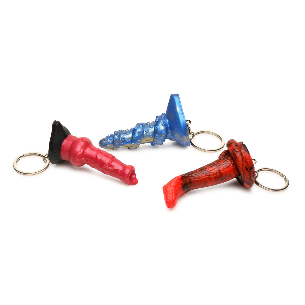 Three fantasy-themed silicone keychains in red, blue, and red/black.