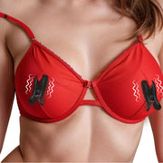 Vibrating nipple clamps with silicone grips on a red bra.
