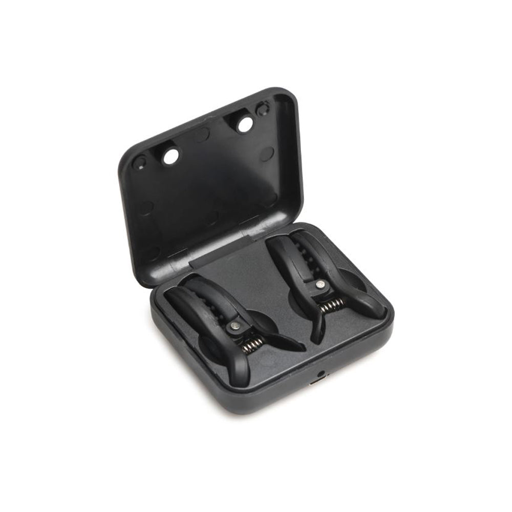 Black vibrating nipple clamps in a charging case.