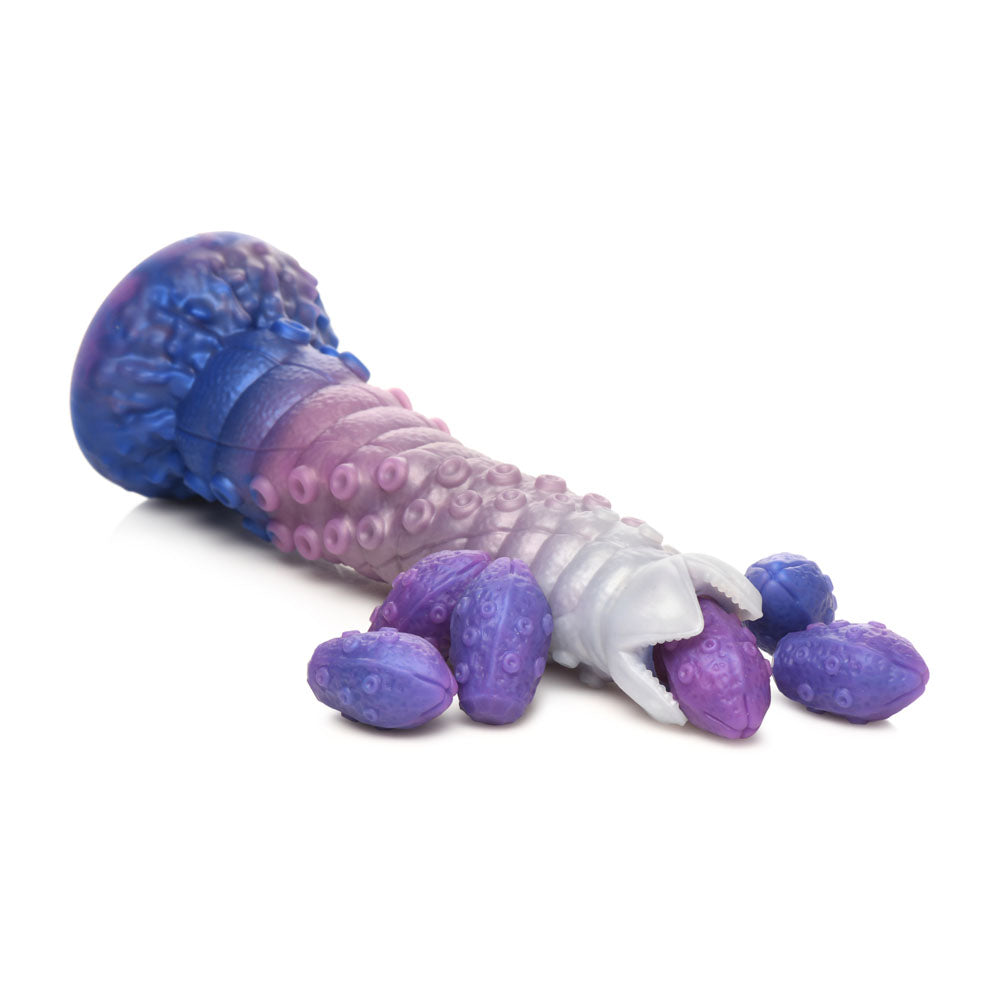 A large, multi-colored silicone dildo with tentacle-like texture and a mouth holding purple eggs.