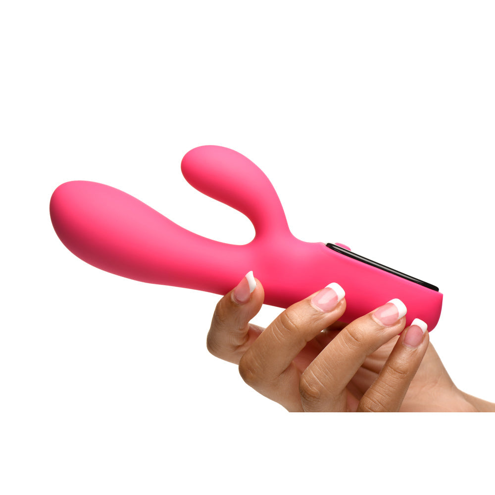 Pink silicone rabbit vibrator held in a hand.