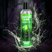 A bottle of Creature Slime water-based lubricant with a green creature design.