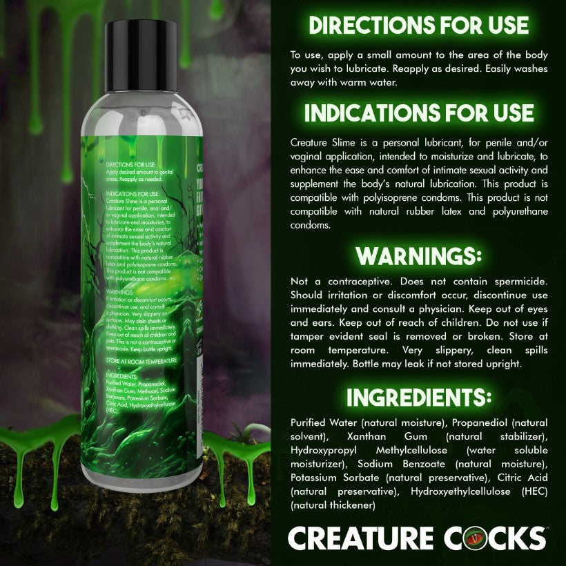 A bottle of Creature Slime water-based lubricant with green slime dripping down the sides.