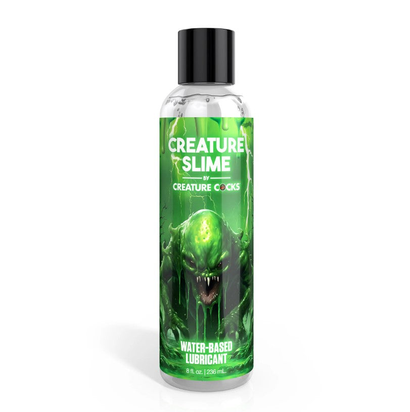 A bottle of Creature Slime water-based lubricant with a green monster illustration.