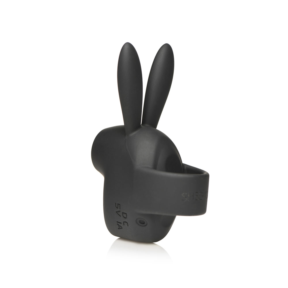 A black silicone rabbit-shaped clitoral stimulator with USB charging port.