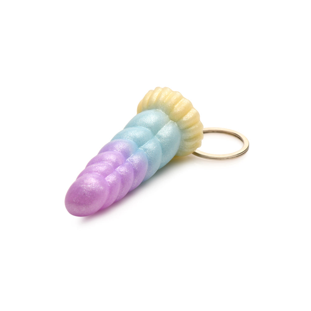 A pastel unicorn horn keychain with purple, blue, and yellow sections.
