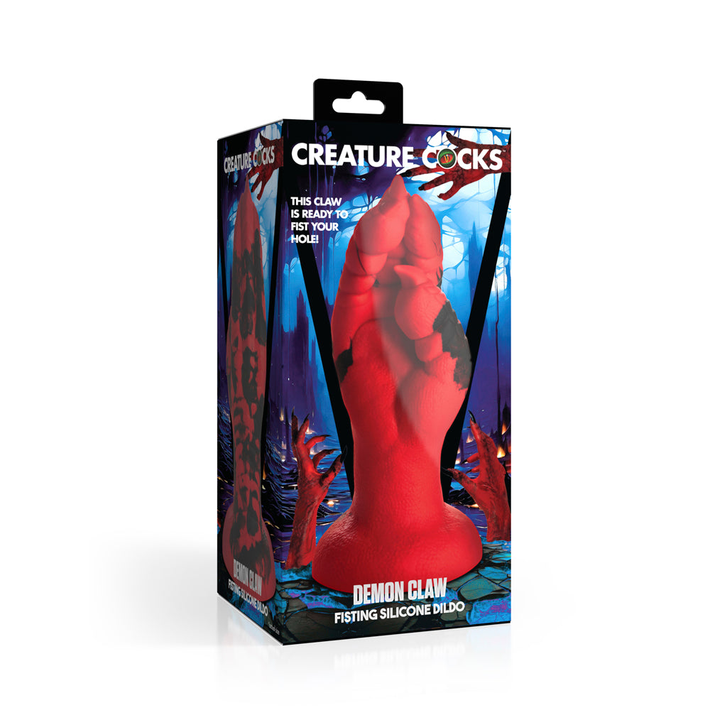 Red silicone dildo shaped like a demon claw with black accents on a box.