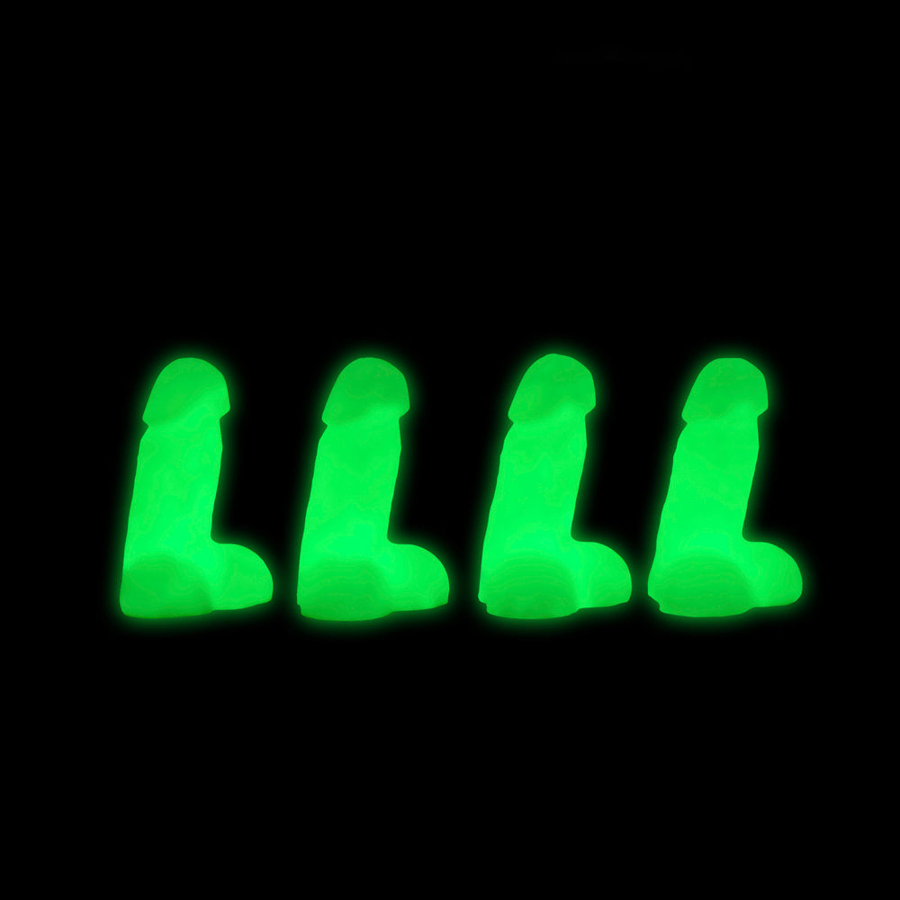 Four glow-in-the-dark mini silicone novelty dildos on a black background.