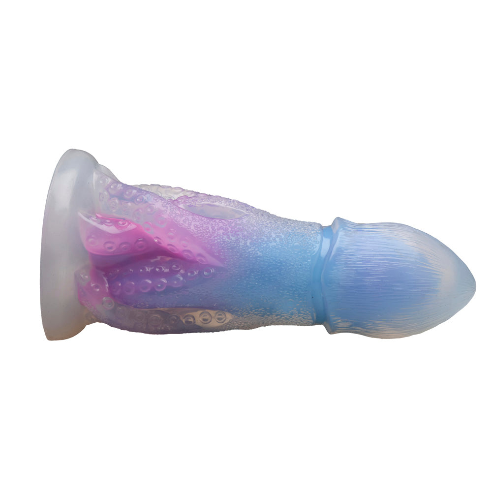 Glow-in-the-dark silicone dildo with octopus tentacles and blue and pink gradient.
