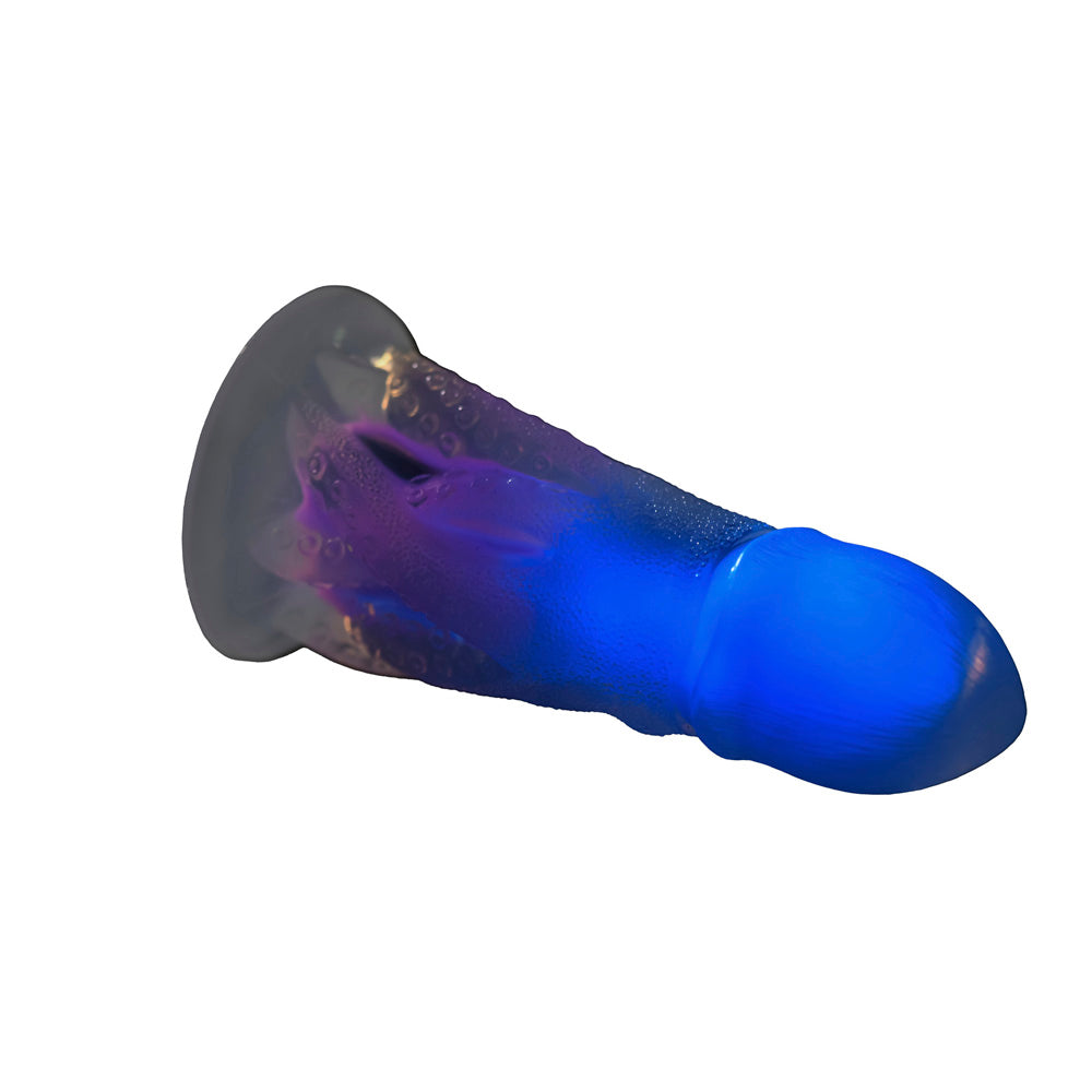 Glow-in-the-dark octopus dildo with textured tentacles and blue tip.