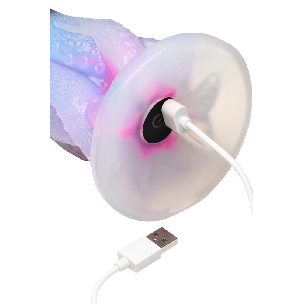 A glow-in-the-dark silicone octopus dildo with a USB charging cable.