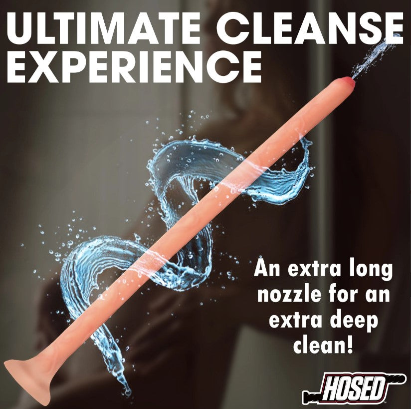 A long, slim, peach-colored silicone enema hose with a flared base and water splashing around it.