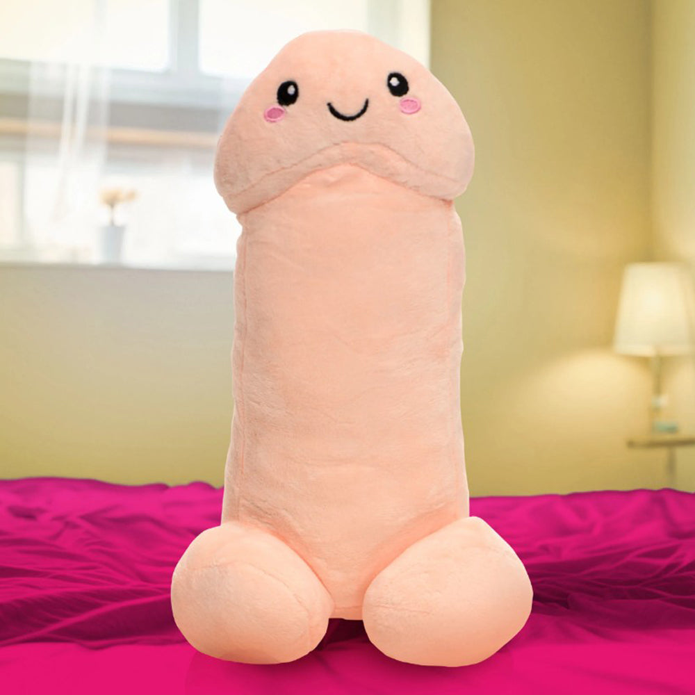 A soft, peach-colored plush pillow shaped like a penis with a smiling face.