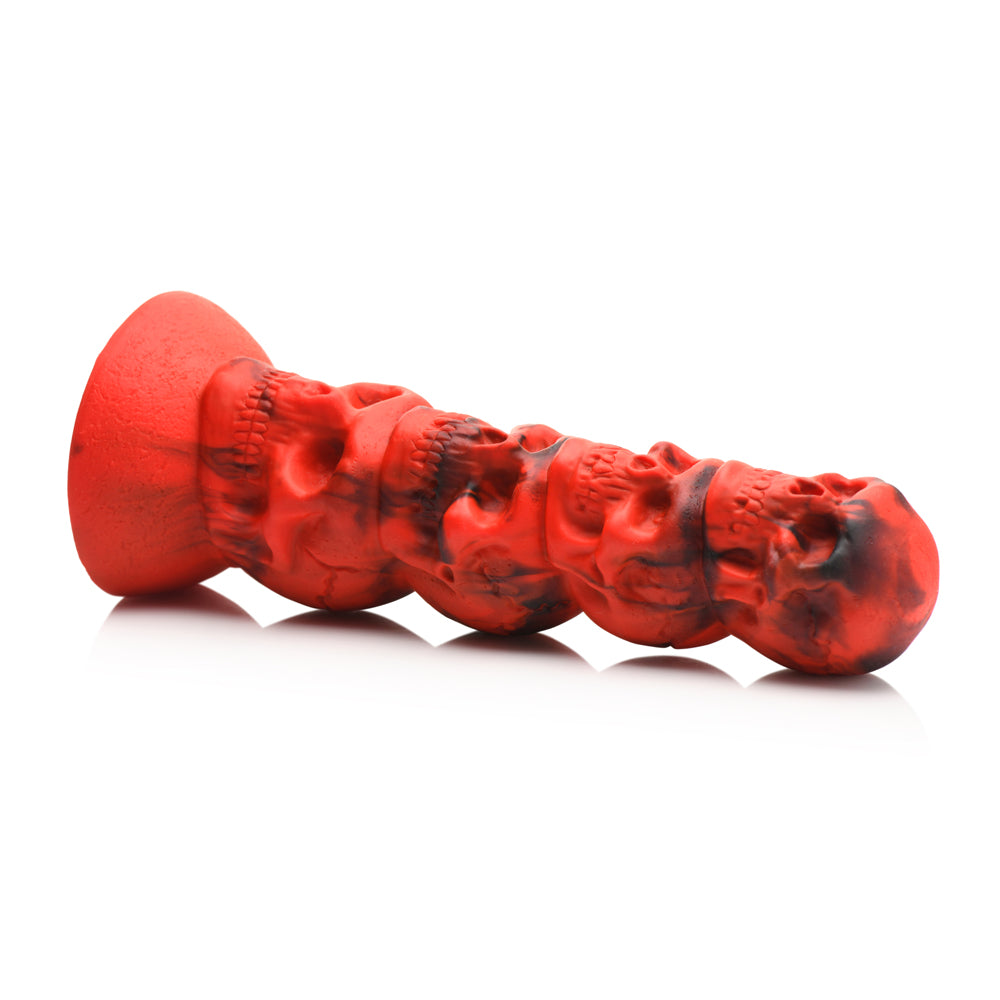 Red silicone dildo with a tower of four skulls and a suction cup base.
