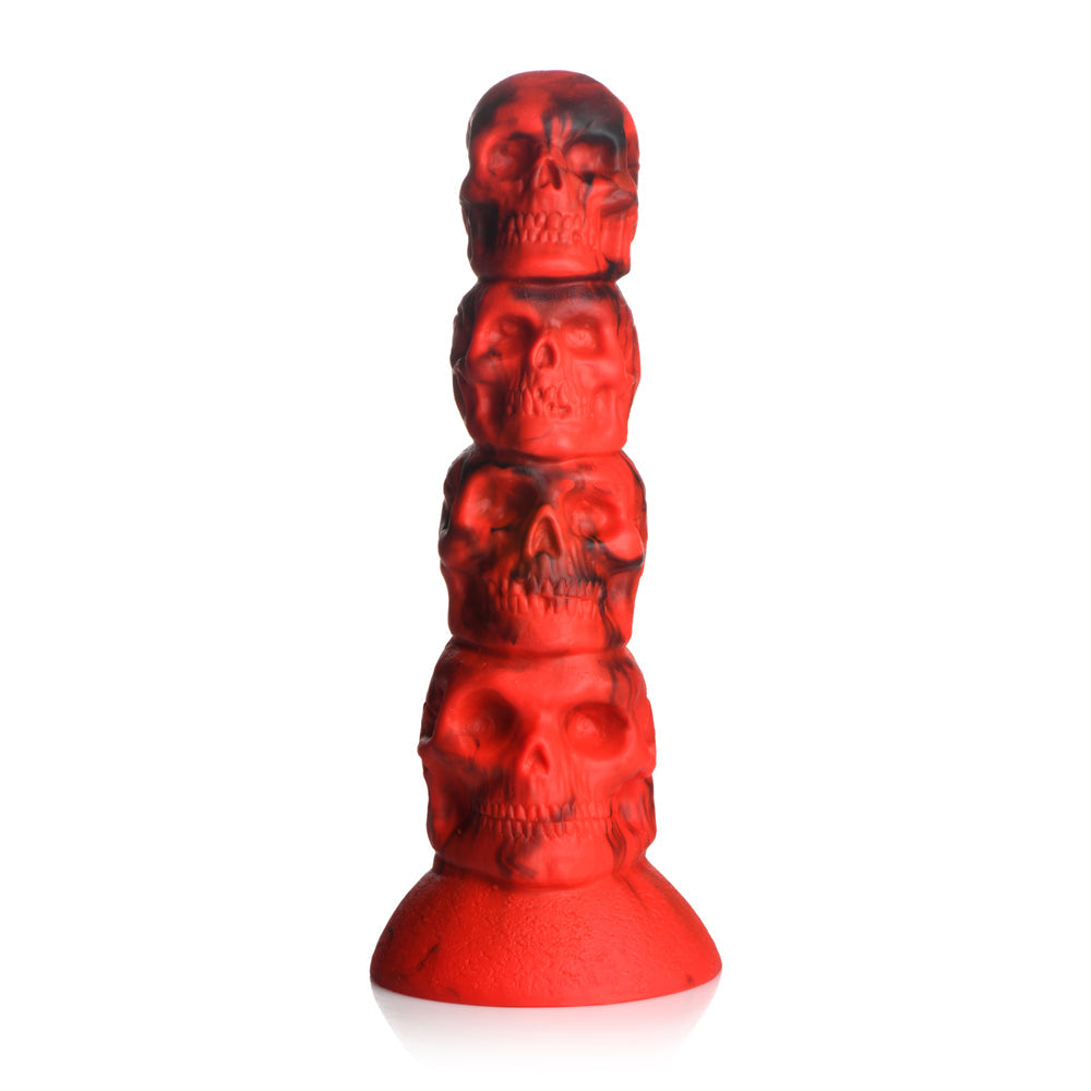 A red silicone dildo with a suction cup base, featuring a tower of four skulls.