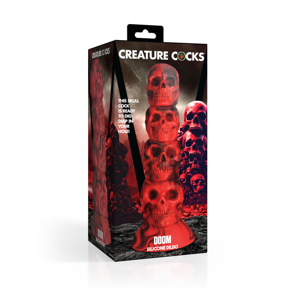 A red silicone dildo shaped like a tower of skulls with a suction cup base.