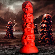 Red silicone dildo shaped like a tower of four skulls with a suction cup base.