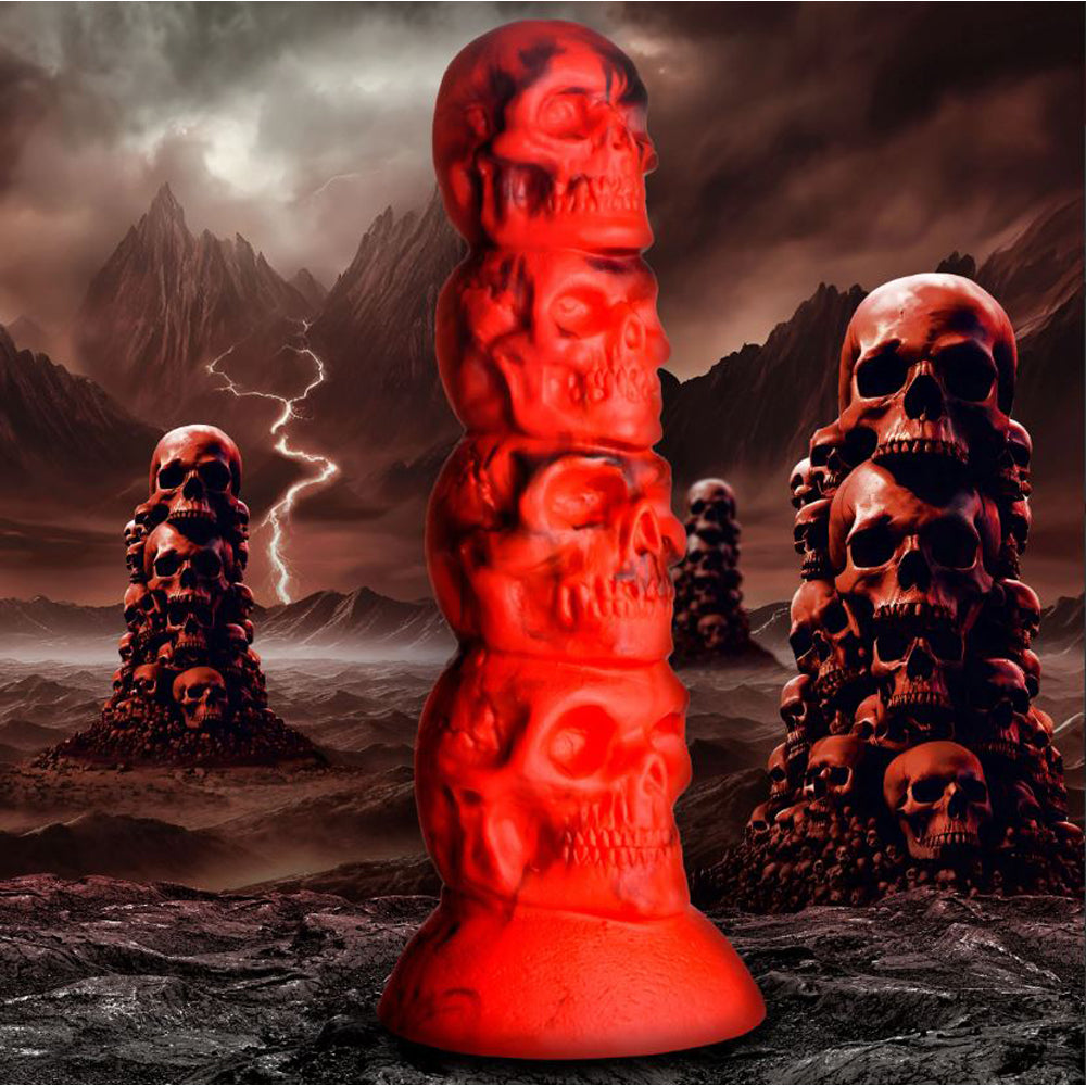 Red silicone dildo shaped like a tower of four skulls with a suction cup base.