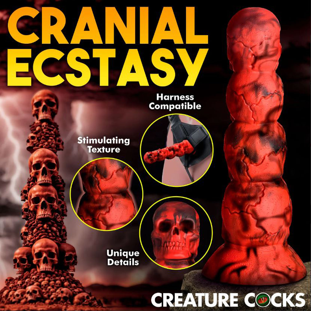 A red silicone dildo shaped like a tower of skulls with a suction cup base.