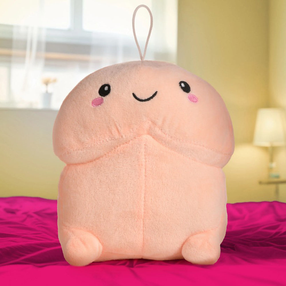 A light pink, plush pillow shaped like a smiling penis with a hanging loop.