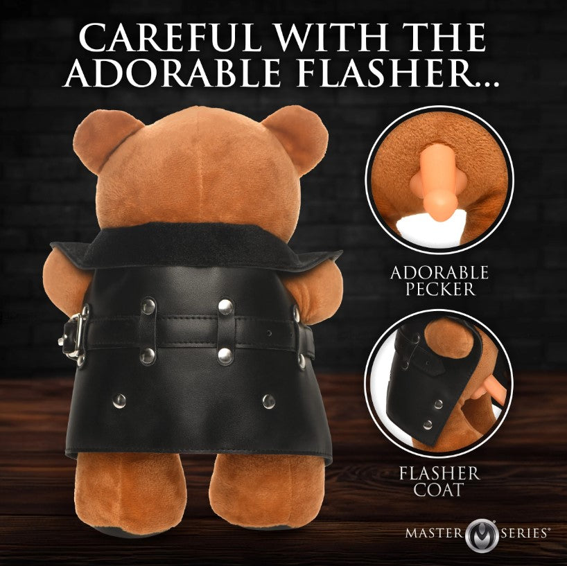 A brown teddy bear wearing a black leather coat with a visible phallic toy.
