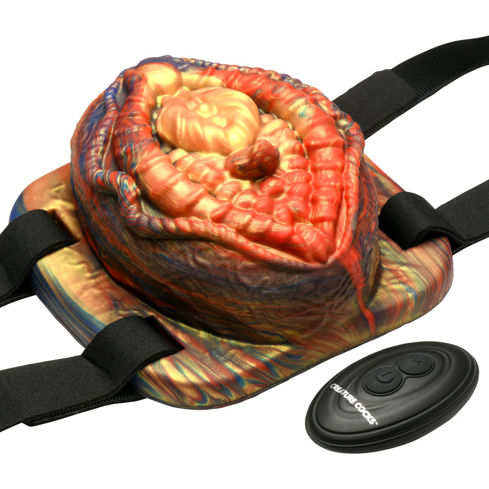Vibrating silicone grinder with remote control and adjustable straps.