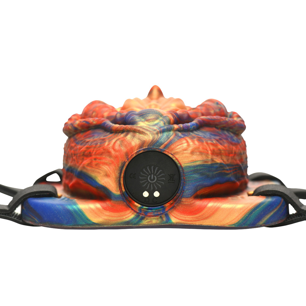 A colorful vibrating silicone grinder with a remote control.