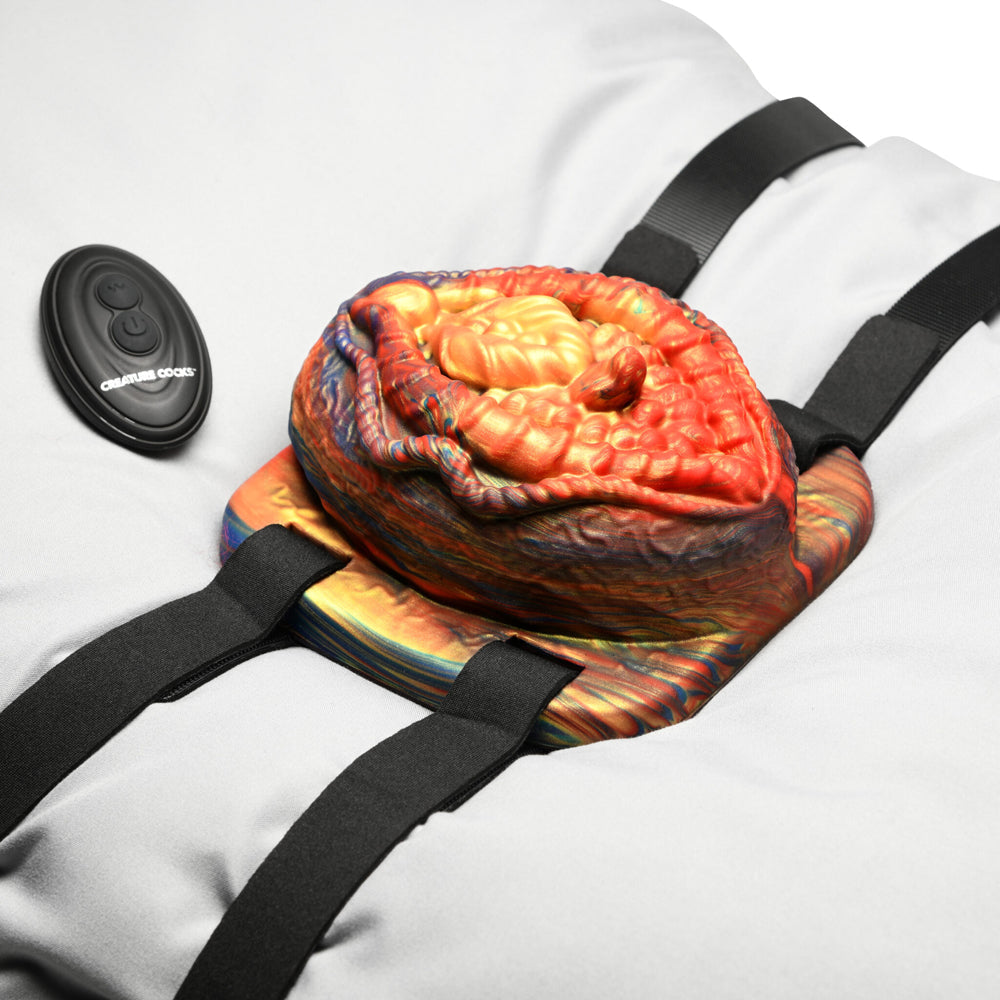 Vibrating silicone grinder with remote control and adjustable straps.