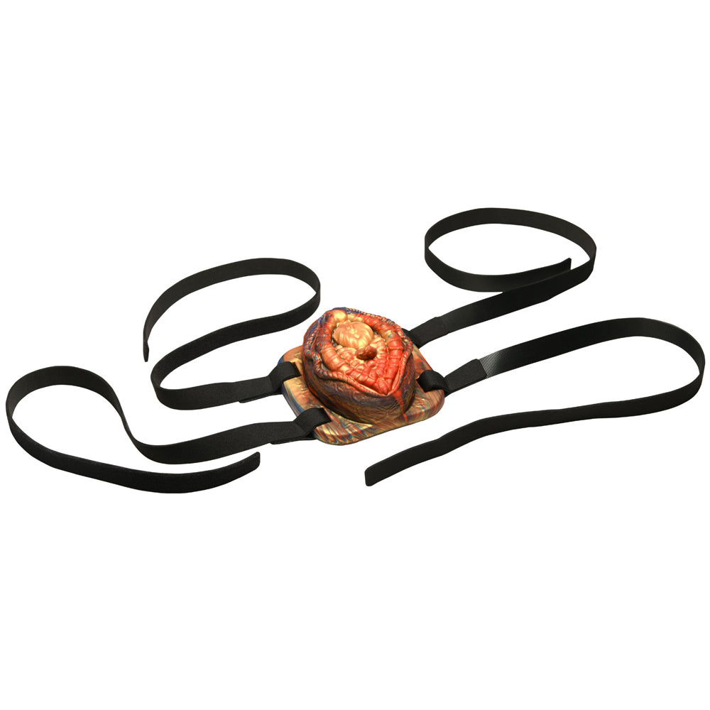 Vibrating silicone grinder with black straps.