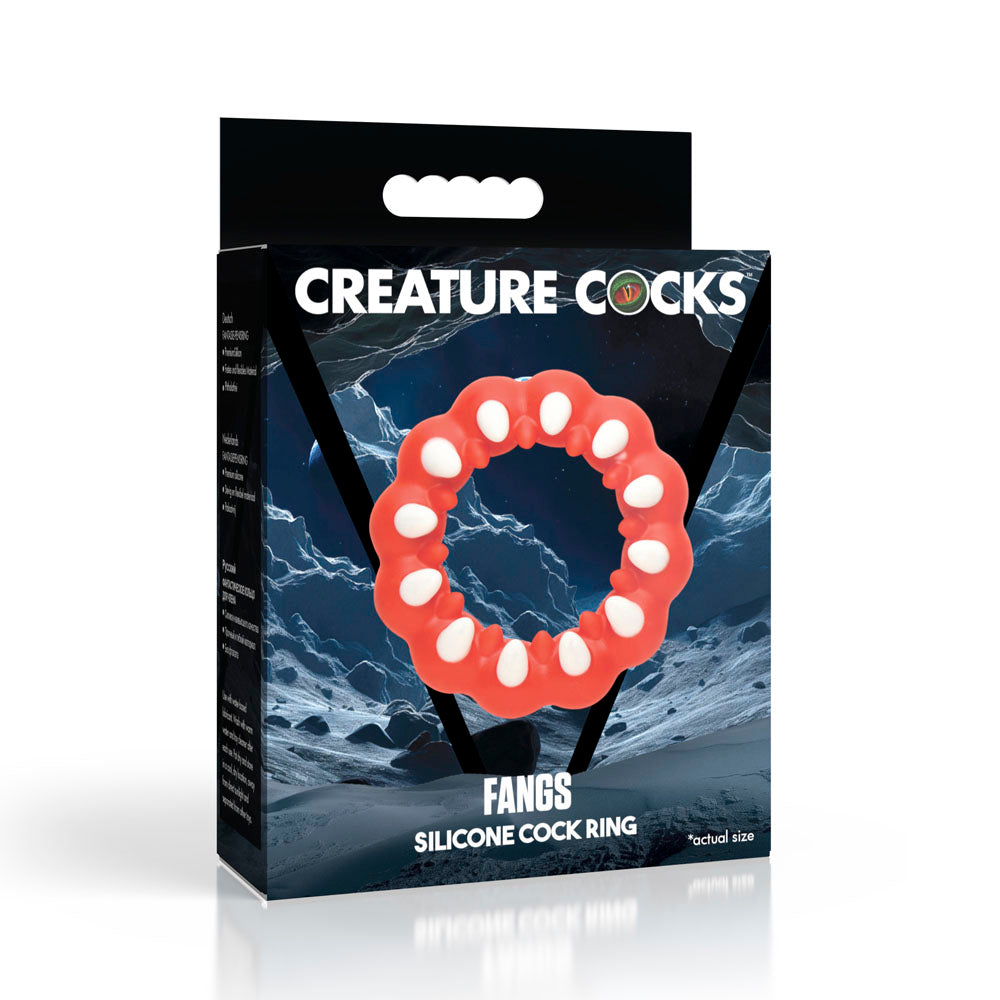 Red silicone cock ring with white textured fangs on a dark background.