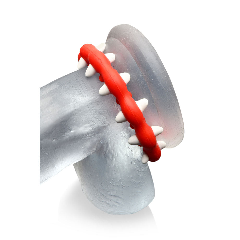 Red and white fangs silicone cock ring with textured surface.