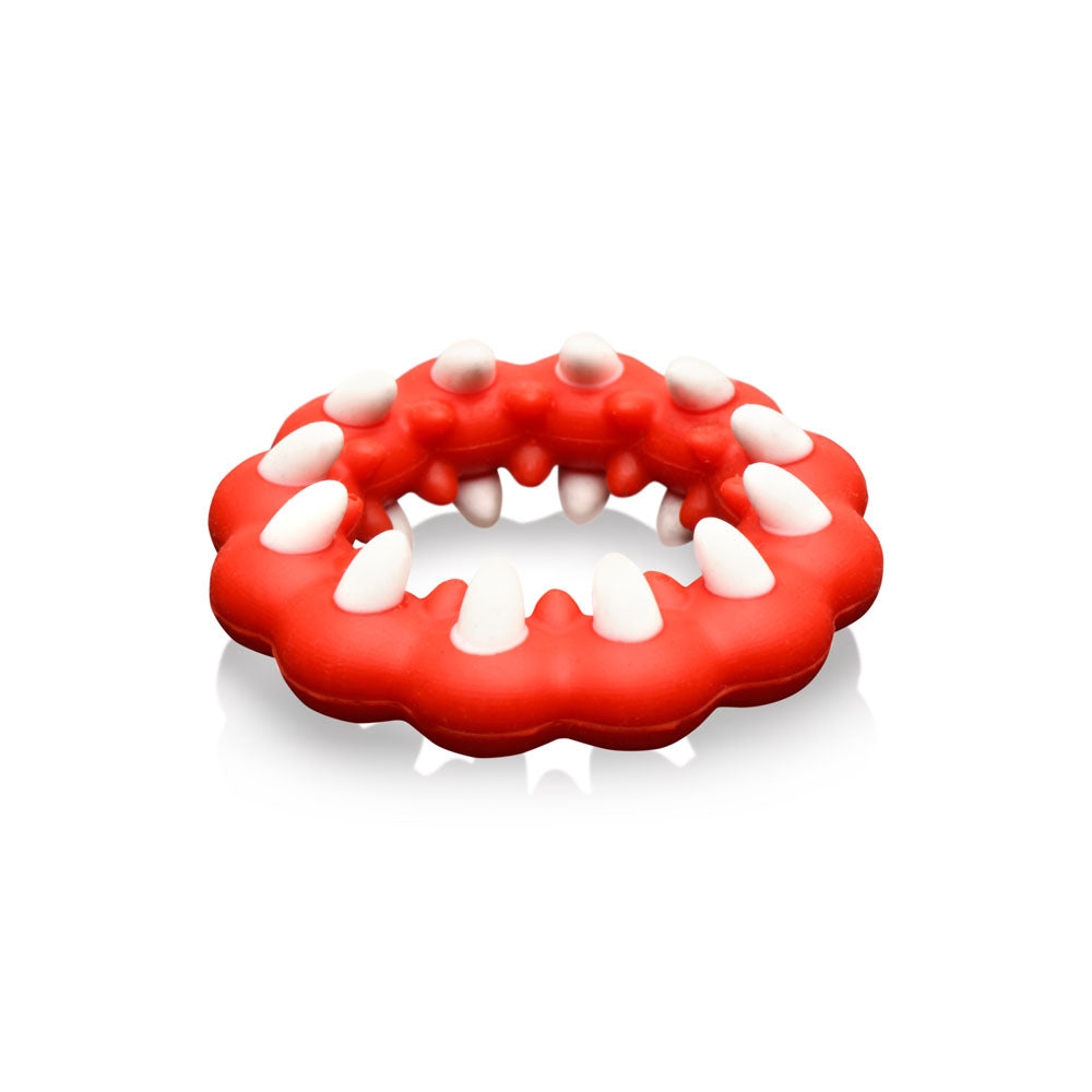 Red silicone cock ring with white fangs and textured bumps.