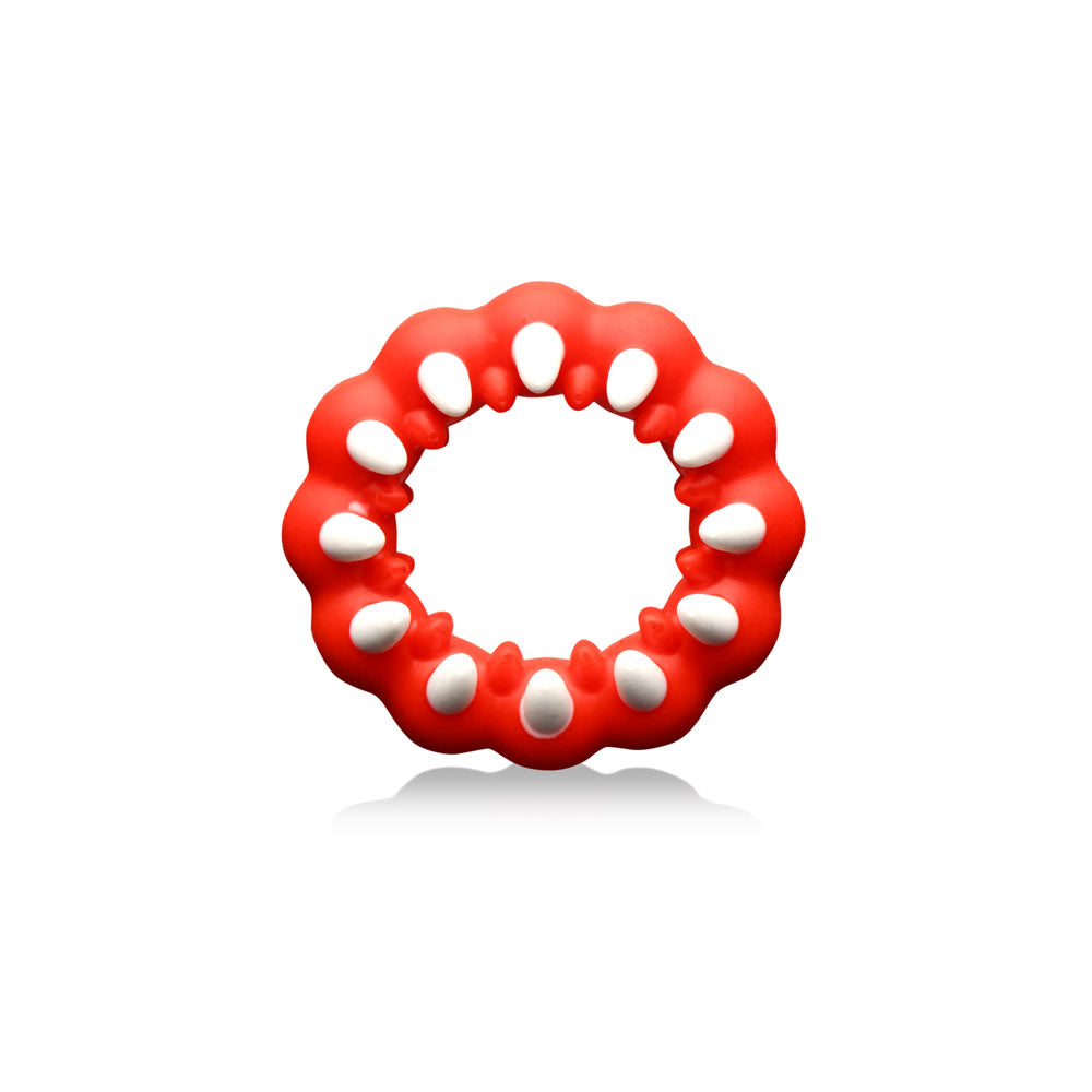 Red silicone cock ring with white fangs and textured bumps.