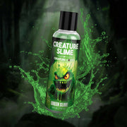 A bottle of Green Slime personal lubricant with a monster graphic.